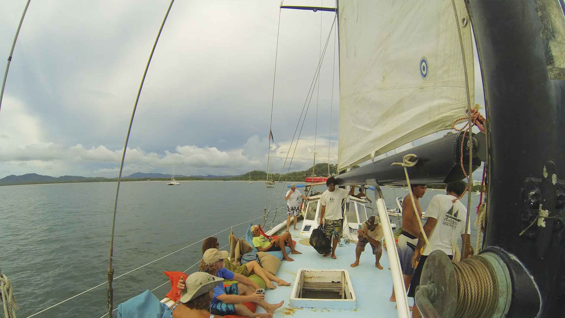 Tourists relaxing on beanbags during a sunset sailing cruise in Playa Grande, Costa Rica