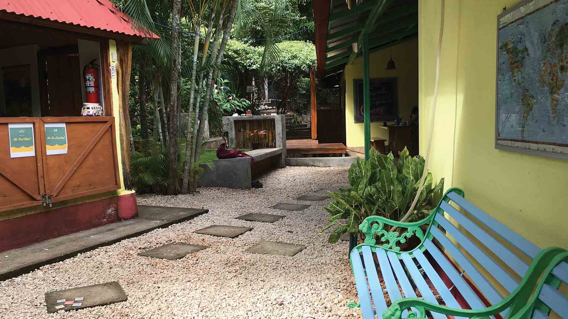 Bench and reception at entrance of boutique hotel in Playa Grande