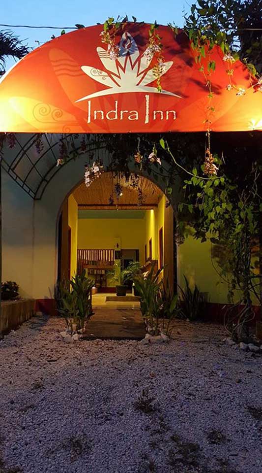 Indra Inn outside entrance overhang sign at dusk in Playa Grande, Costa Rica