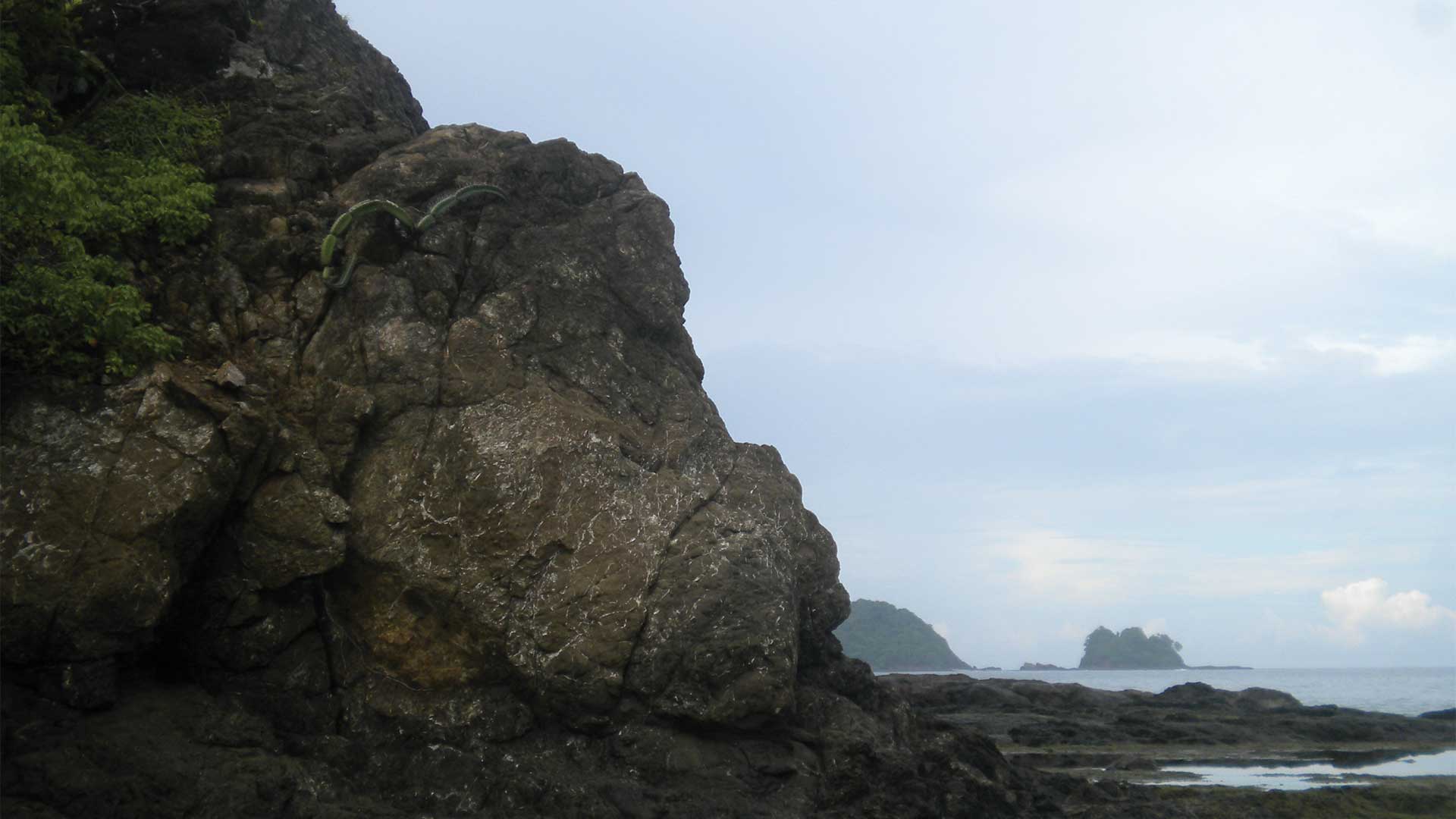 Back rock boulder island on a hidden beach in Guanacaste, Costa Rica