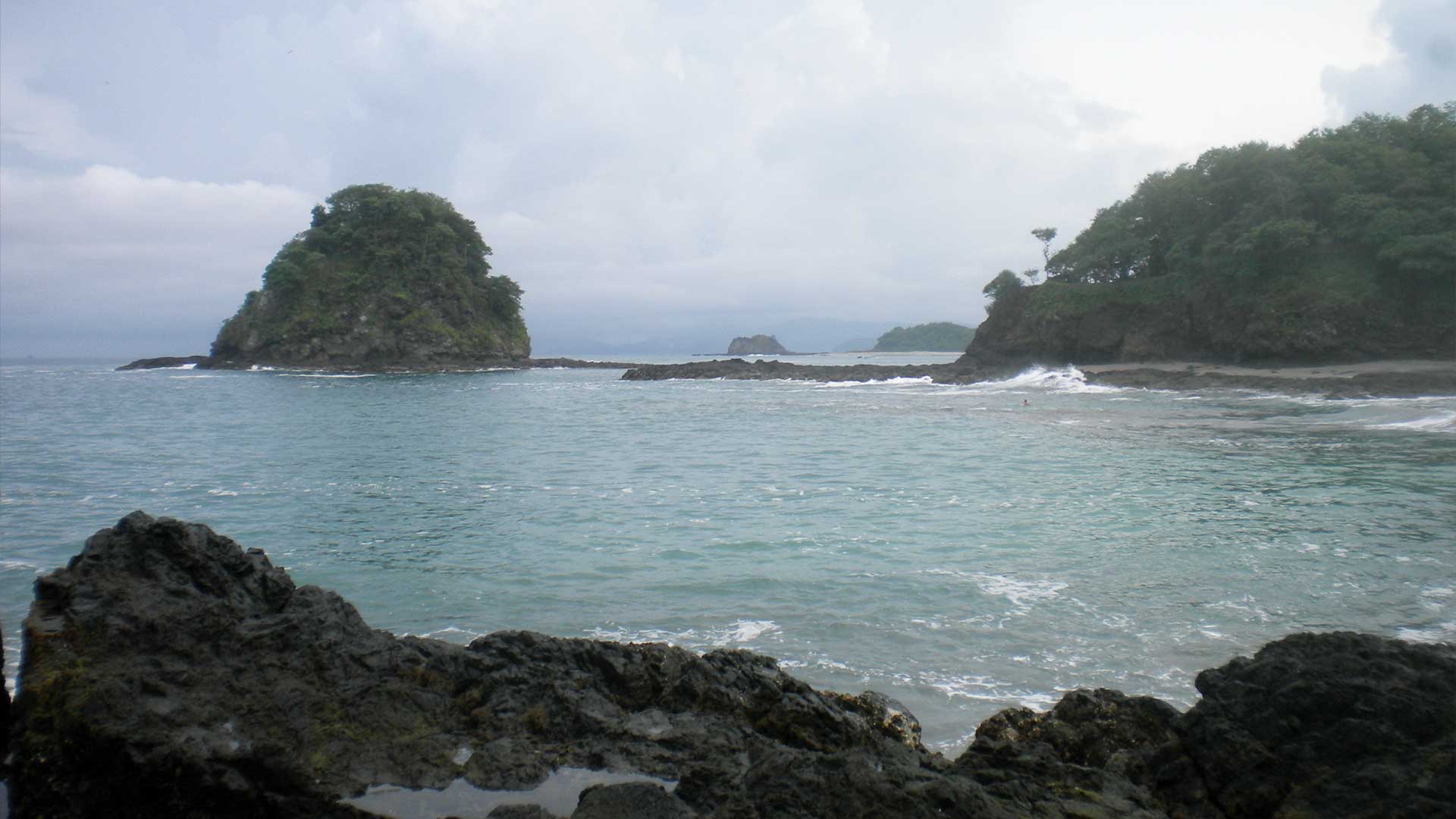 Black rocky beach with small islands in Guanacaste, Costa Rica