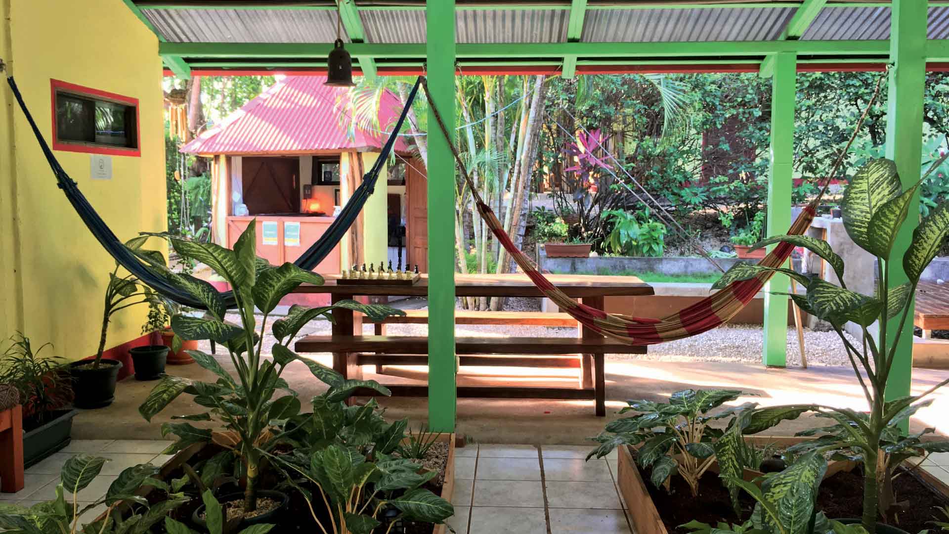 Hammocks and table behind indoor gardens at boutique hotel in Playa Grande, Costa Rica