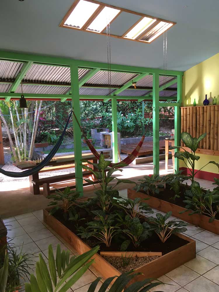 Indoor gardens and hammocks in lounge at boutique hotel Indra Inn