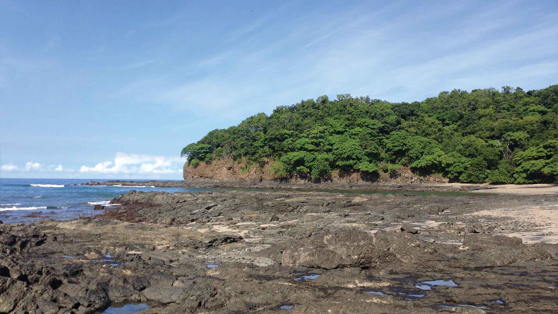 Black rock beach at Playa Carbon in Guanacaste, Costa Rica