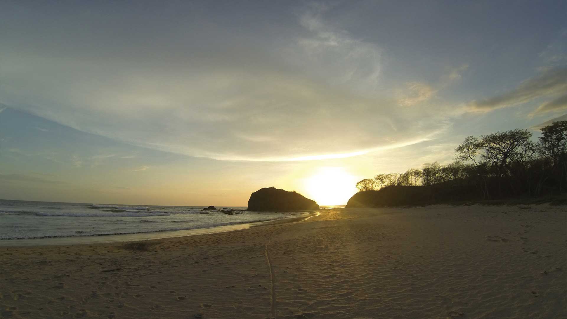 Sunset on an open sandy beach in Playa Grande, Costa Rica