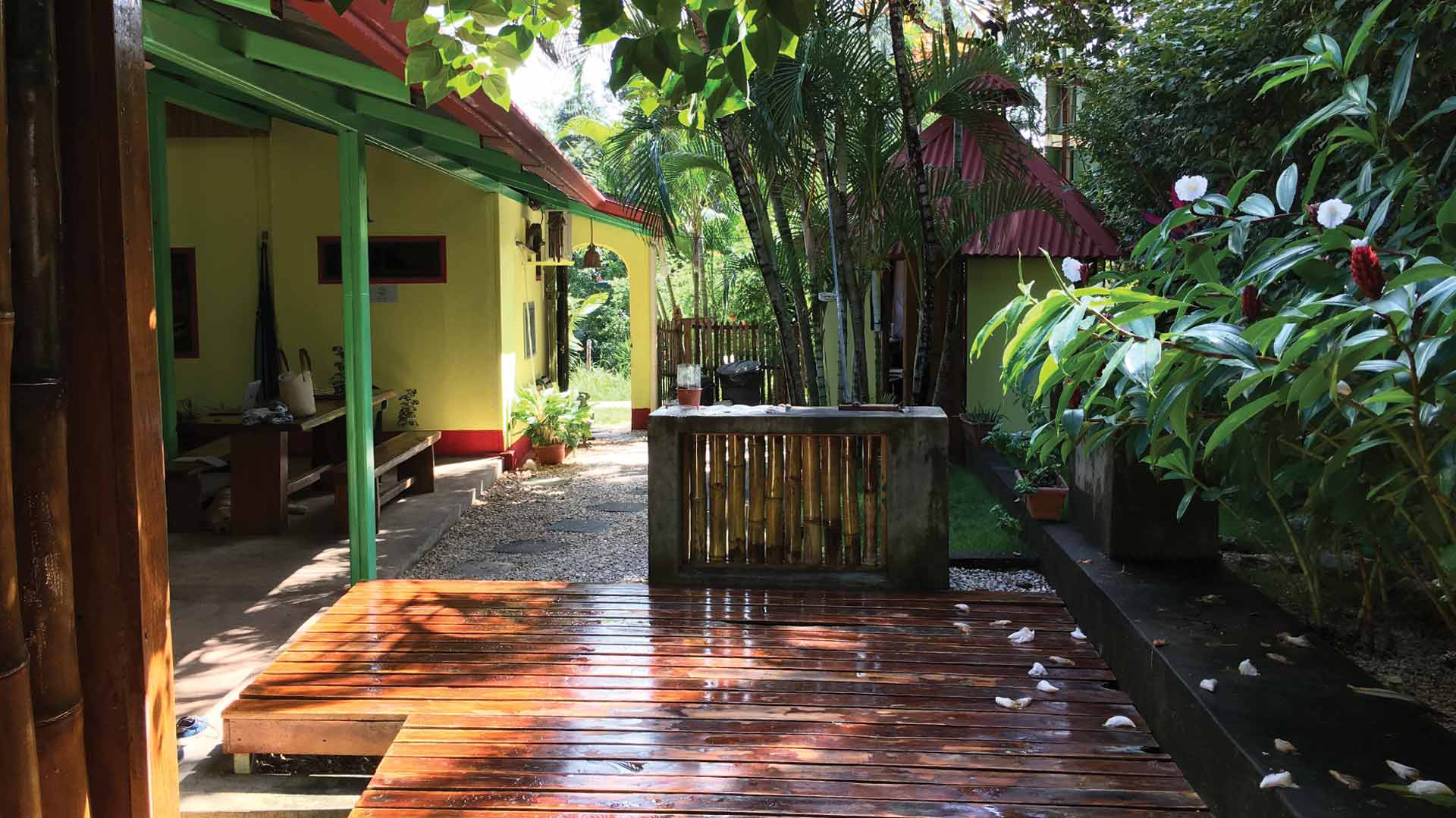 Sun terrace in flower gardens at boutique hotel Indra Inn in Playa Grande, Costa Rica
