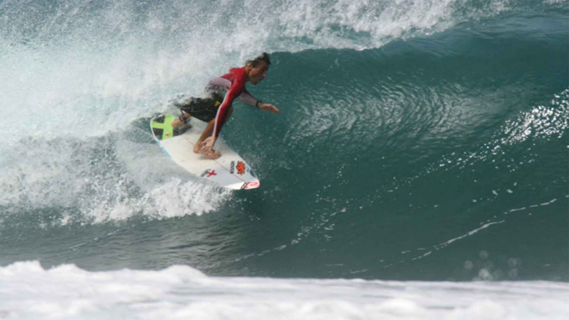 A surfer surfing n a tube wave at Playa Grande, Costa Rica