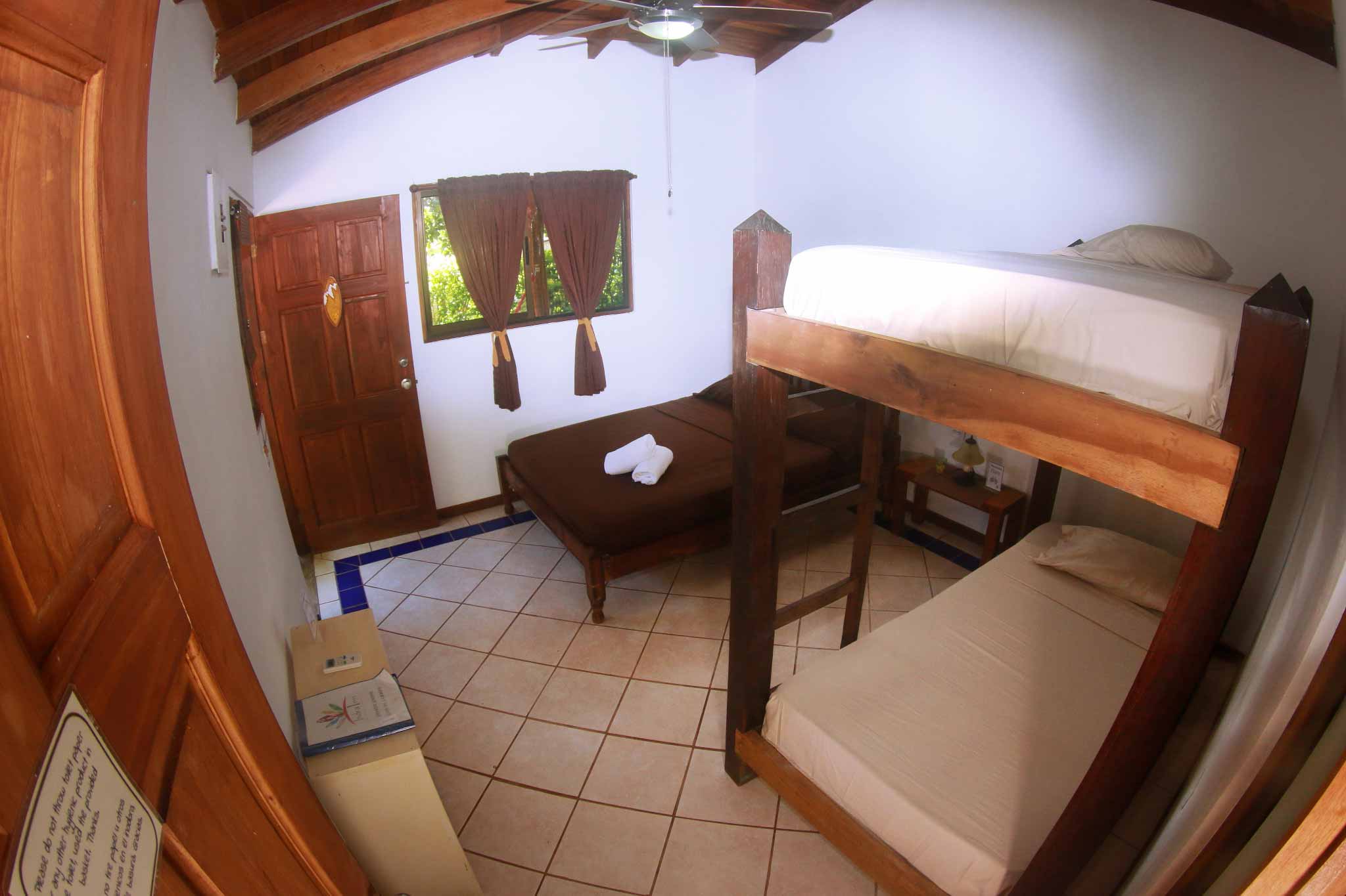 Bunk bed and double bed in a triple room at Indra Inn