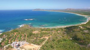 Birds-eye aerial of ocean bay and land at Tamarindo and Playa Grande in Guanacaste, Costa Rica