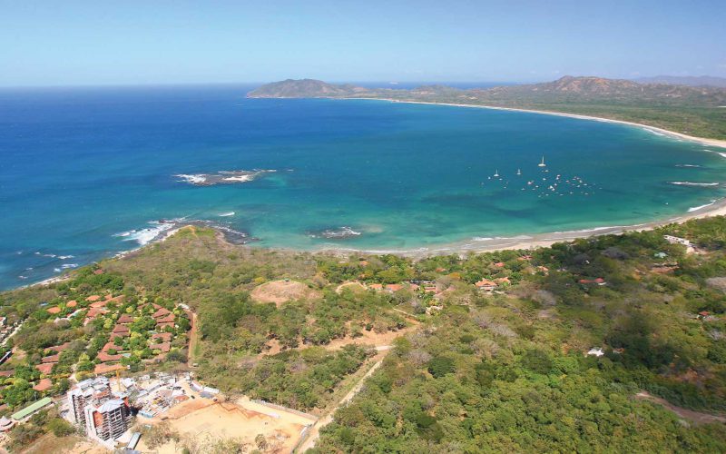 Birds-eye aerial of ocean bay and land at Tamarindo and Playa Grande in Guanacaste, Costa Rica