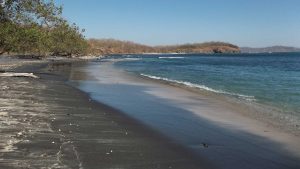 Black sand empty beach at Playa Carbon in Guanacaste, Costa Rica