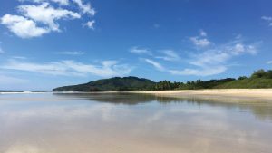 A landscape reflection of Playa Grande beach at low tide