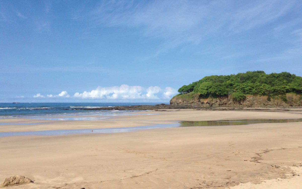 Wide sandy beach at low tide at Playa Ventana in Guanacaste, Costa Rica