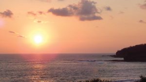 Pink sunset over Playa Ventana flat ocean in Guanacaste, Costa Rica
