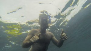 Man snorkeling with two thumbs up in Playa Grande, Costa Rica