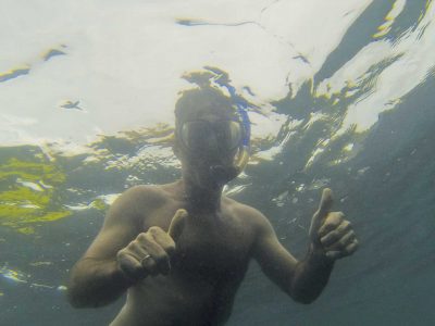 Man snorkeling with two thumbs up in Playa Grande, Costa Rica