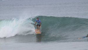 A surfer surfing a wave at Playa Grande, Costa Rica